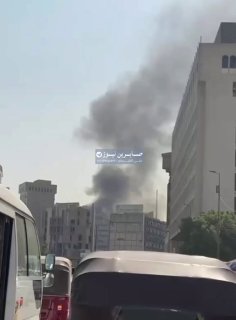 Piles of smoke rise over the approaches to Al-Khalani Square in Baghdad