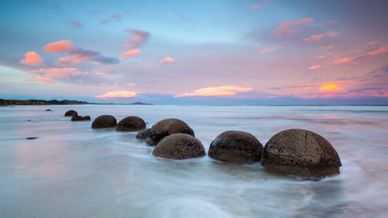 Rocks and rollersMoeraki Boulders at sunset, South Island, New Zealand (© Douglas Pearson/eStock Photo)
