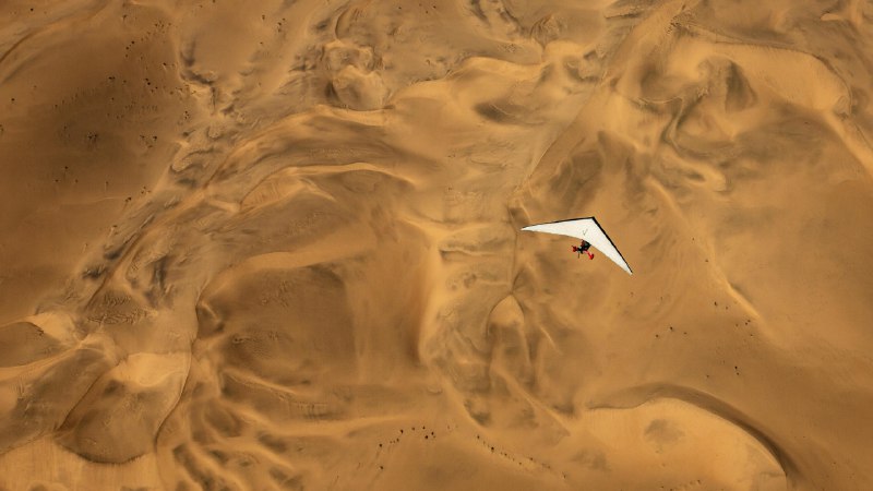 Not your average desert tripAn ultralight aircraft flying over the sands of Namibia (© Burt Johnson/Alamy)