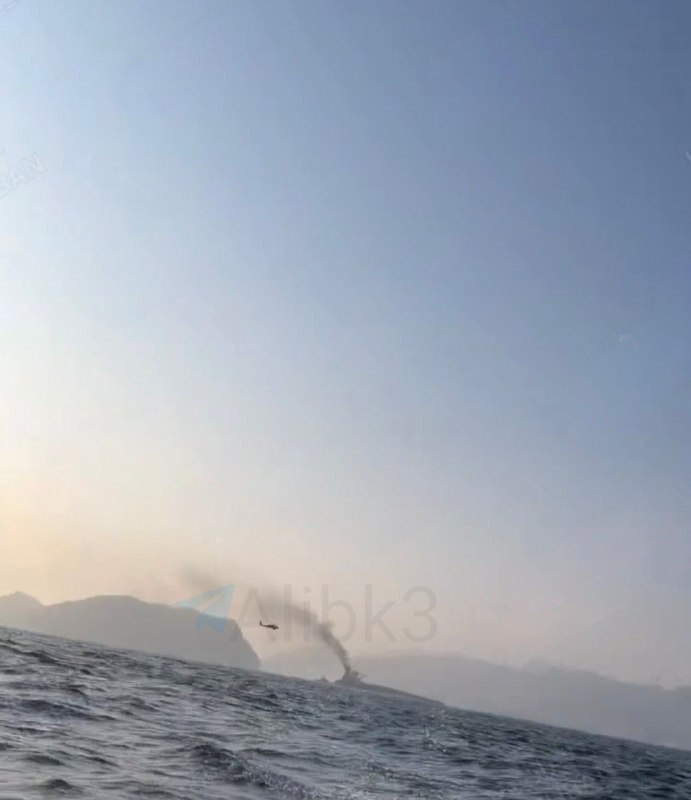 Pictures taken by Iranian fishermen in the Strait of Hormuz of an oil tanker on fire, and a helicopter flying nearby, possibly American.