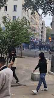 Rioters throw stones and huge bricks at police cars in Lyon, France.