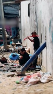 תחת חום השמש הקיצית ובין אוהלים מנסים ילדים פלסטינים ברצועת עזה לקרר את גופם בכמה טיפות מים.