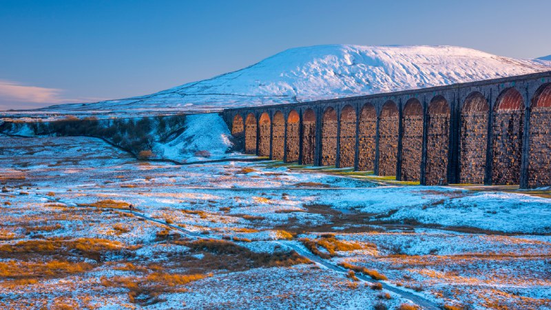 Bridging history, one arch at a timeRibblehead Viaduct and Ingleborough mountain, North Yorkshire, England (© AWL Images/DanitaDelimont.com)