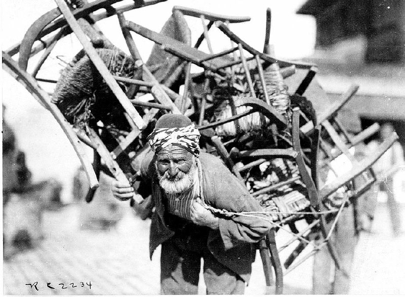 An enterprising resident of Constantinople earns money by carrying folding chairs on his back and renting them out for 10 cents to tired tourists. Constantinople, 1920.Time Machine | Historical Photo
