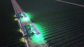 autonomous robot driving through the field at night.