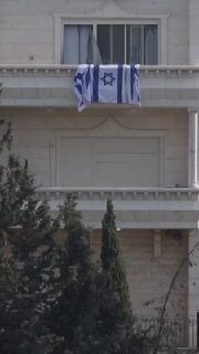 After forcing its residents to evacuate, the IDF raises Israeli flags over a Palestinian building that has been turned into a military barracks in the city of Hebron in the West Bank.