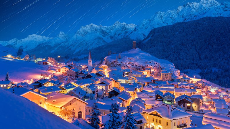 The glistening villageStar trails over Ardez, Graubunden, Switzerland (© Roberto Moiola/Getty Images)