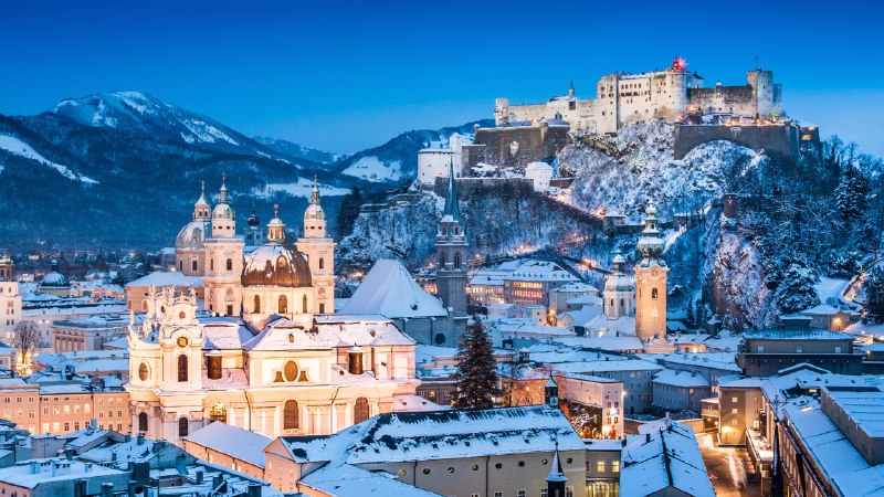Twinkling streets and icy peaksSalzburg, Austria (© bluejayphoto/Getty Images)