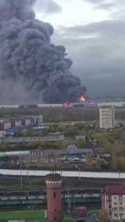 Rotating scenes show a fire breaking out in a warehouse in St. Petersburg following an announced Ukrainian attack, while Ozone confirmed its logistics center was targeted, and Moscow reported fires at an oil refinery and fuel depot.