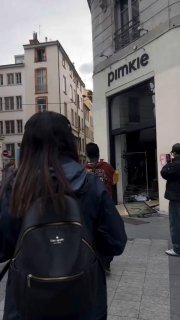 A man scolds his wife for participating in shoplifting in France and forcibly returns the stolen items to the store.
