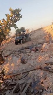 A settler walks around Palestinian houses and throws stones at them in the town of Araba, southwest of Jenin.