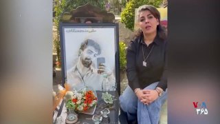 Ali Manoochehrabadi’s mother, one of the victims of the events of Dey 1404, lights a candle in memory of her son