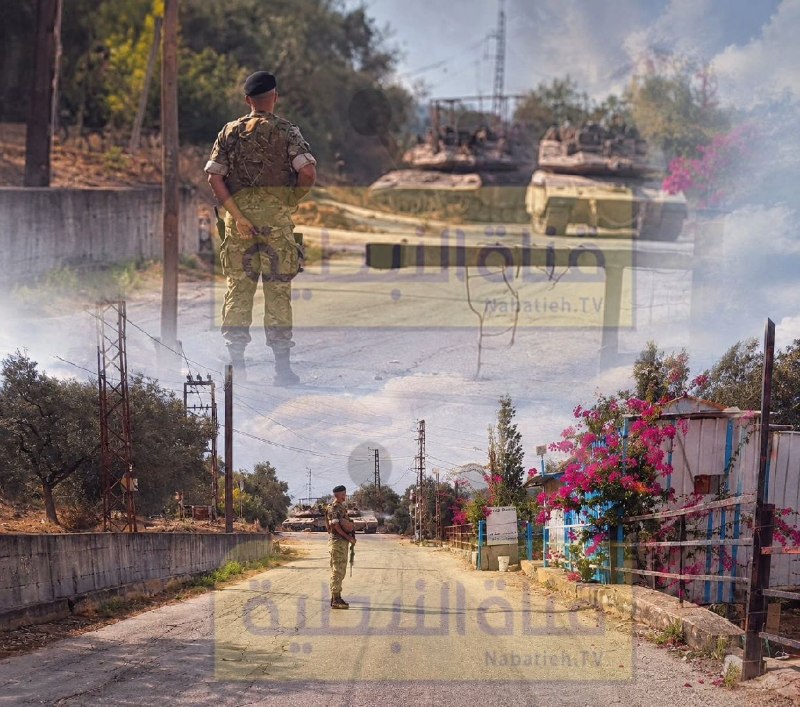 A photograph that reflects the image of Lebanese army personnel
