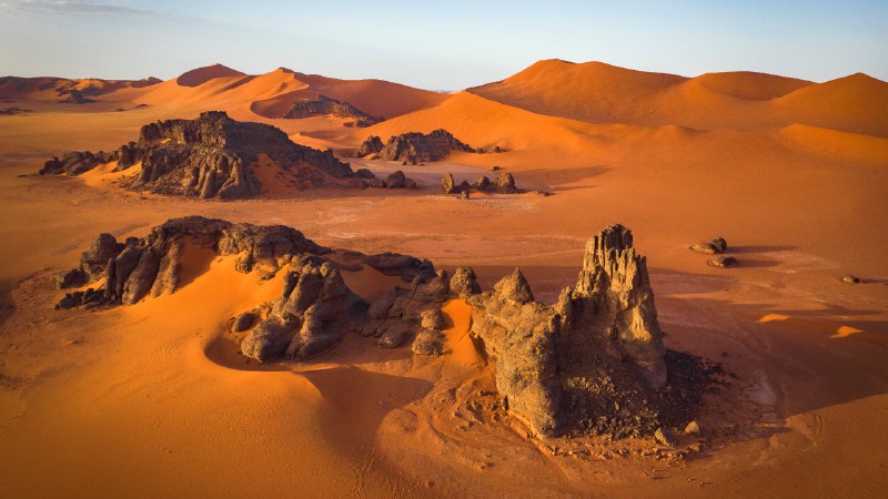 Dune days and desert hazeRock formations and sand dunes in the Sahara, Tassili n’Ajjer, Algeria (© Airpano/Amazing Aerial Agency)