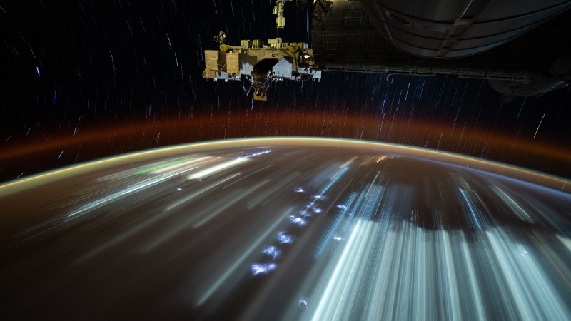 The first step off EarthCity lights streak below, taken from the International Space Station (© NASA)