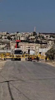 The occupation forces erect iron gates at the entrance to the town of Arena, east of Jenin.