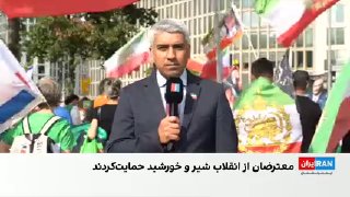 Iranian residents in Berlin hold a protest rally, hoist the Lion and Sun flag