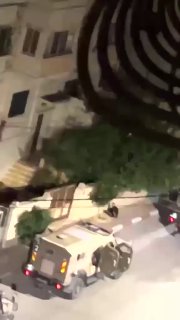 The occupation forces arrest a young man during their assault on the al-Makfia neighborhood, west of Nablus.