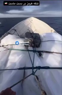 Watch: Iranian fishermen patrol the Strait of Hormuz while US-backed oil tankers burn in the distance.