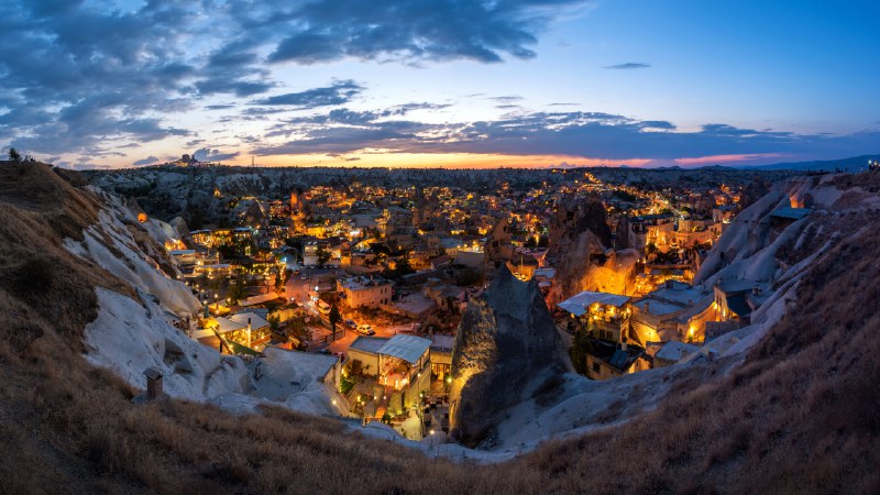 Ancient rocks, modern lightsEvening over Göreme, Cappadocia, Türkiye (© ONNAJA/Getty Images)