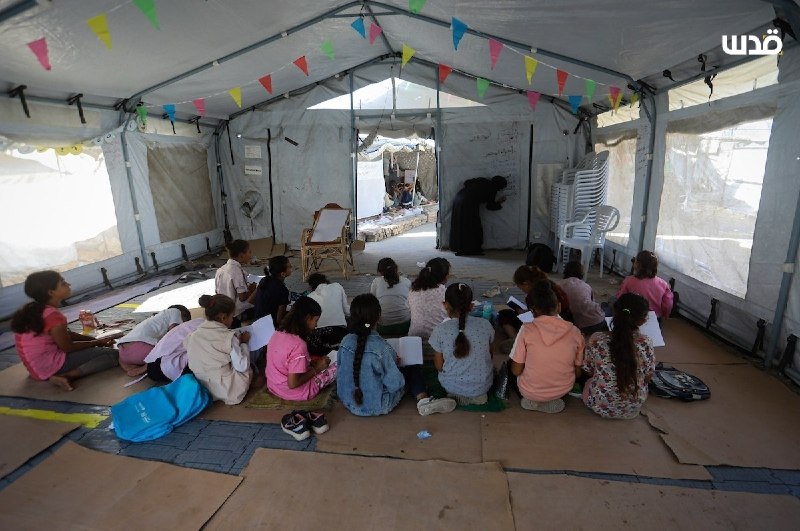 Children receive their lessons in a temporary educational tent west of Gaza City, among thousands of children who are resuming their studies in light of the widespread destruction of schools and the lack of basic facilities and equipment.