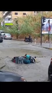A video is circulating of a delivery worker whose bicycle drowned due to floods in Lebanon, so another worker helped him