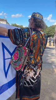 Watch: A Jewish protester in Berlin was arrested after displaying a modified Israeli flag with the Star of David replaced by a rocket/missile outline.