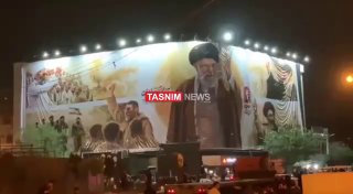 לקראת הלוויית ח'אמנאי: סמל אגרוף קפוץ עם הכיתוב "צריך לקום" בכיכר המהפכה בטהראן