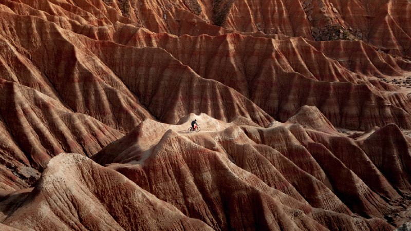 Where the road stops, the ride beginsCyclist in Bardenas Reales Natural Park and Biosphere Reserve, Navarra, Spain (© Artur Debat/Getty Images)